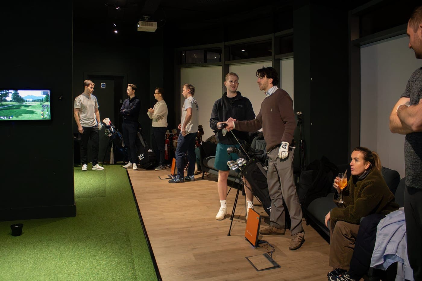 A group with their clubs in a bay at Caddi Club Fulham