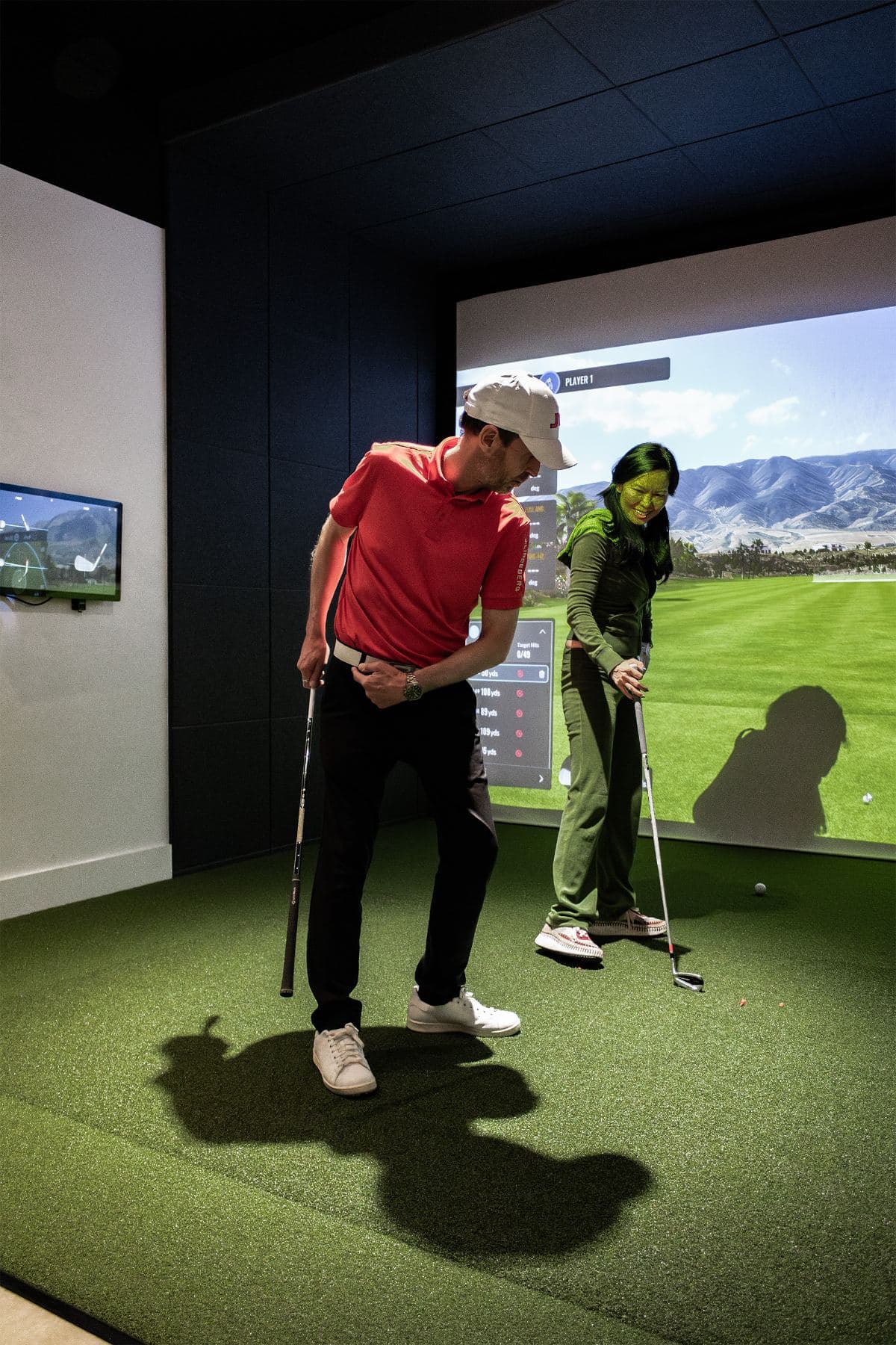 Golf lesson in London: PGA coach guiding a player mid-swing at Caddi Club, southwest London