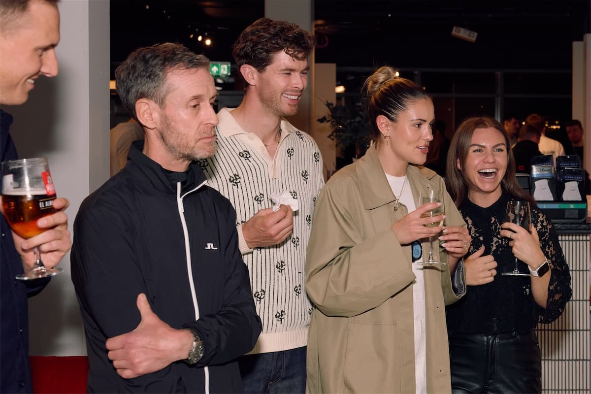 Members laughing together over drinks at a Caddi Club night