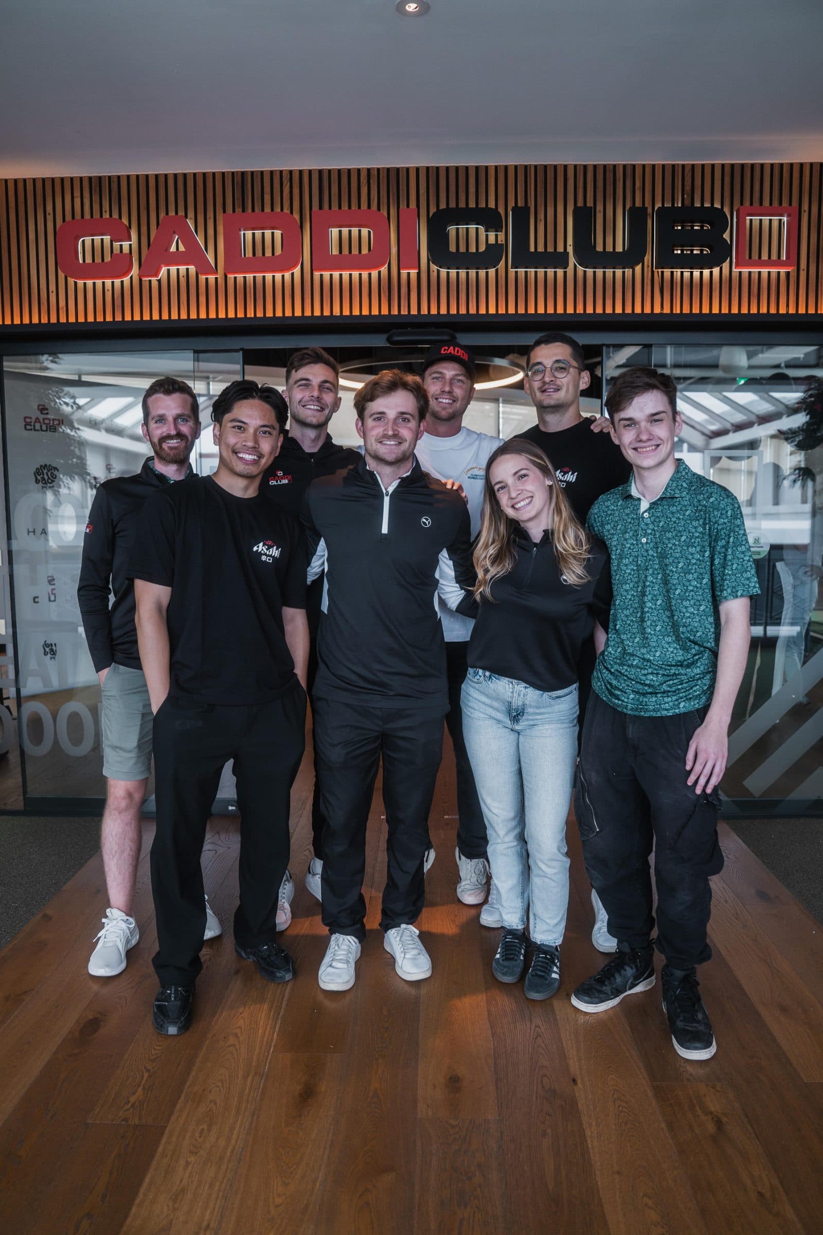 The Caddi Club team under the Caddi Club sign at Wimbledon