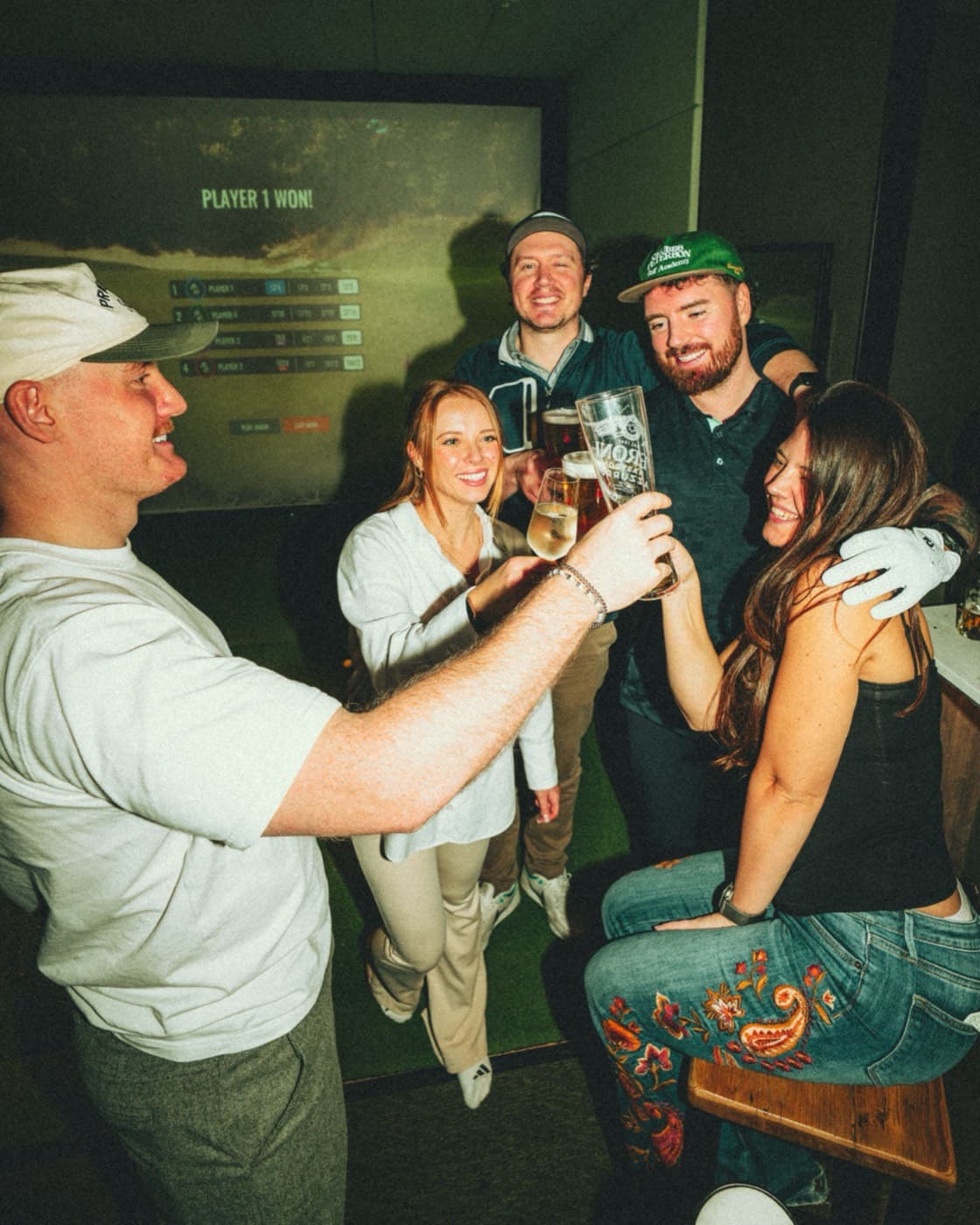 A group raising their glasses in a simulator bay